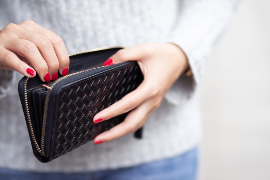 Female hands holding open a wallet.