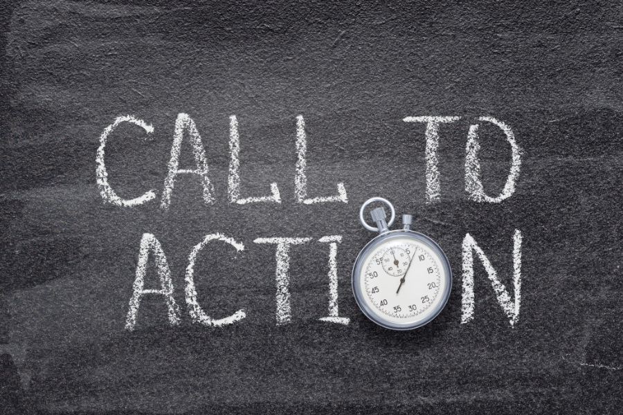 'Call to action' written in chalk on a chalk board with vintage watch used instead of 'O'